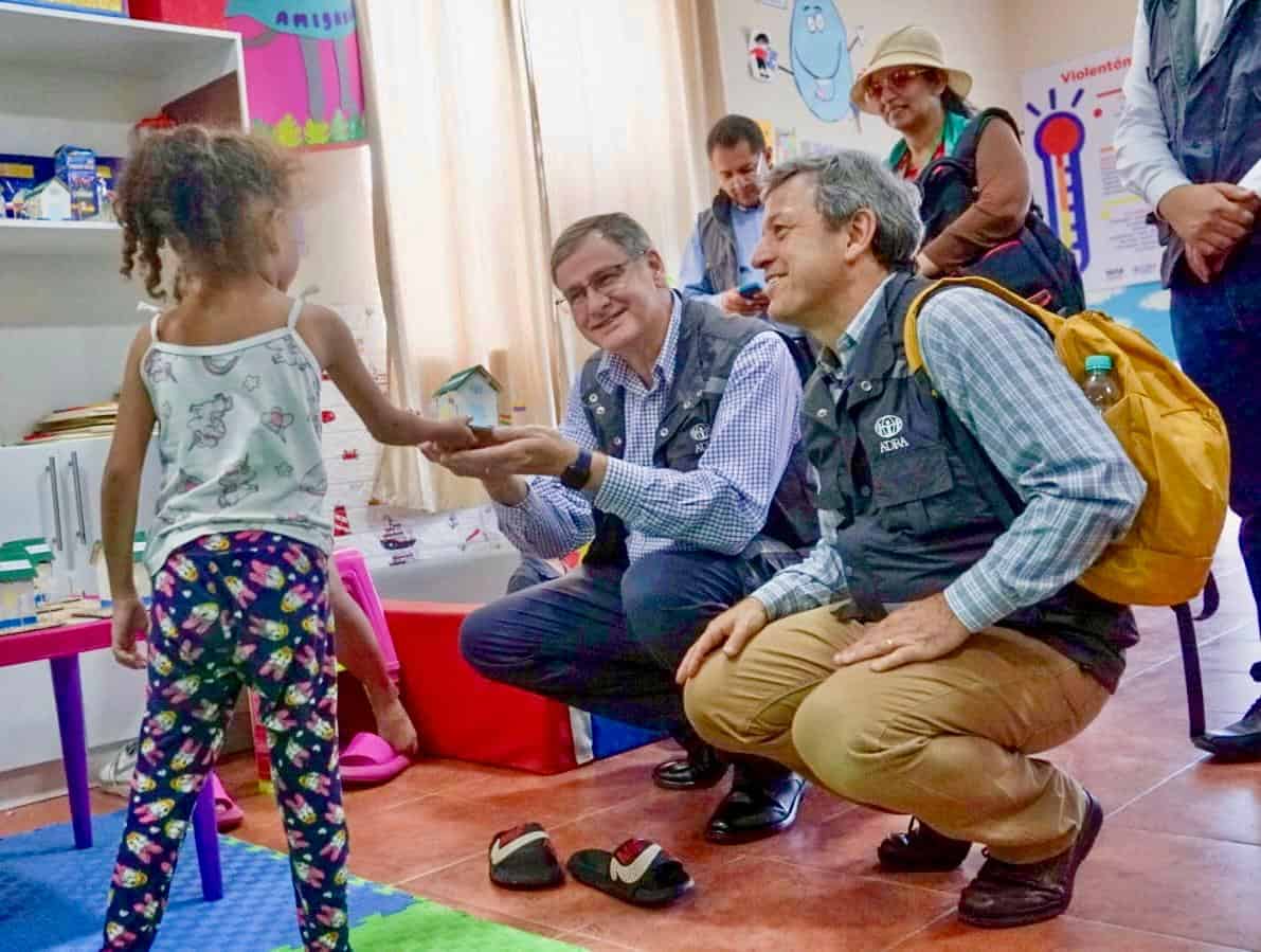 [ADRA International President Paulo Lopes and former ADRA president Michael Kruger meet kids on the Ecuador and Peru border]
