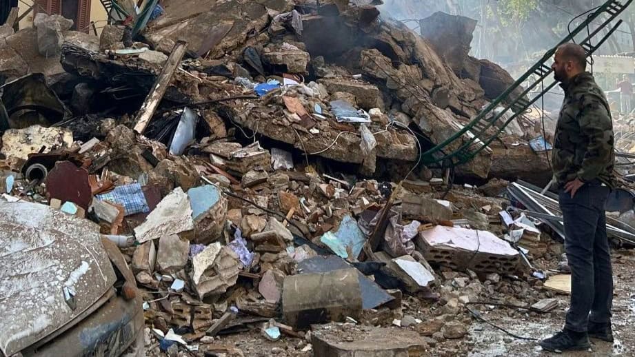 Earthquake disaster relief efforts by ADRA International amidst destruction and debris.