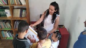 Accessible, diverse group of children with a teacher in a library promoting education in developing.