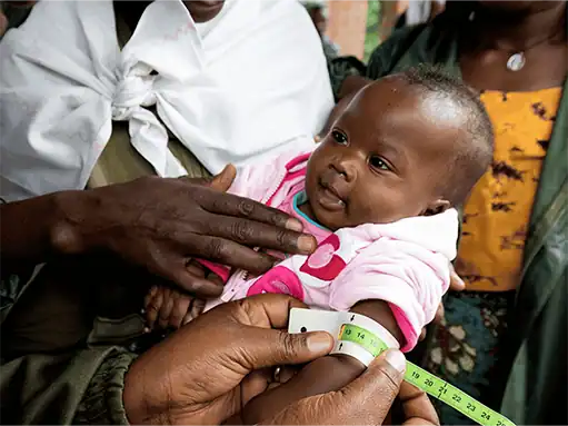 Malnutrition screening for a young child at an ADRA International health outreach.