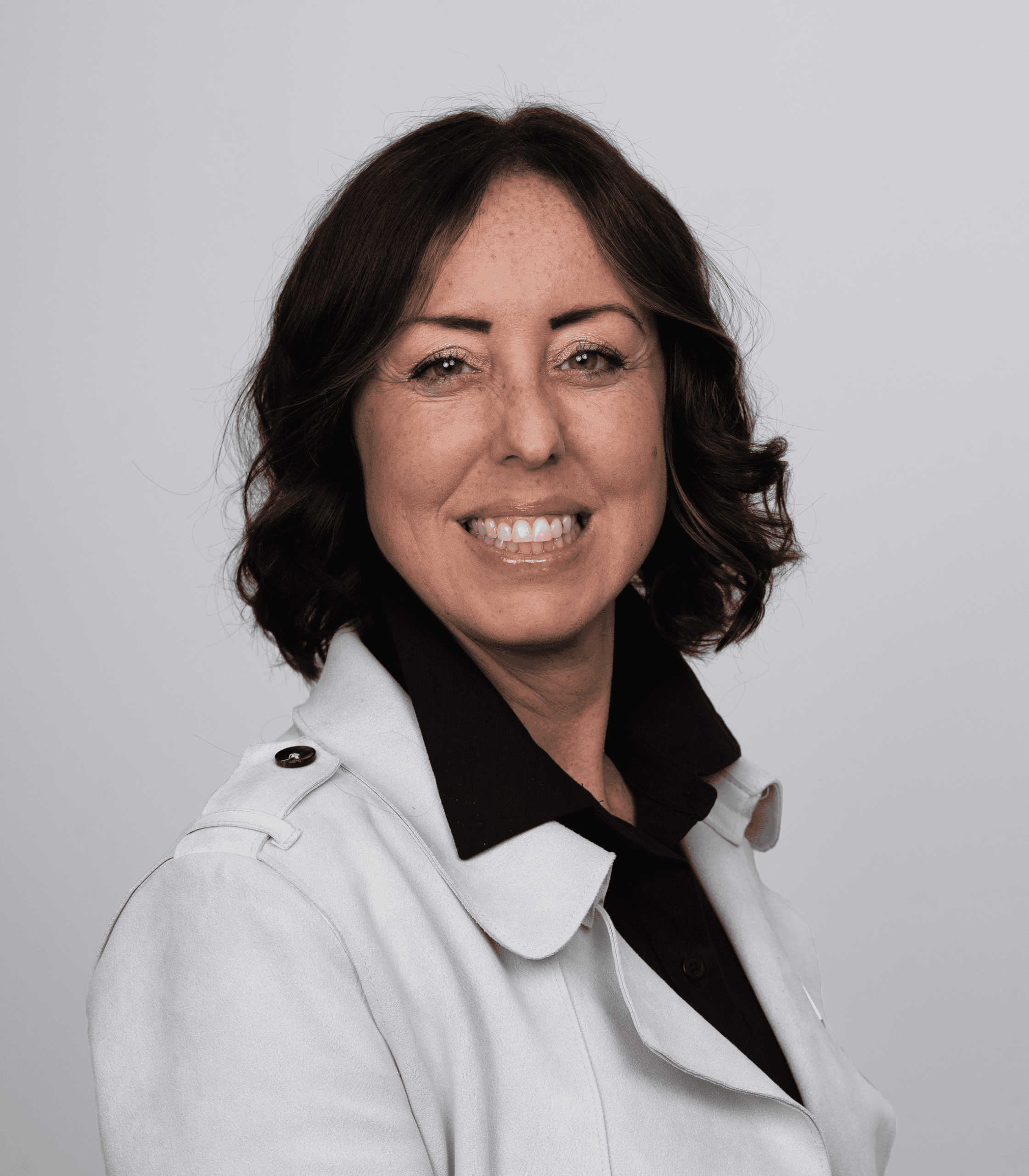 Empowered female leader smiling, representing leadership and community support.