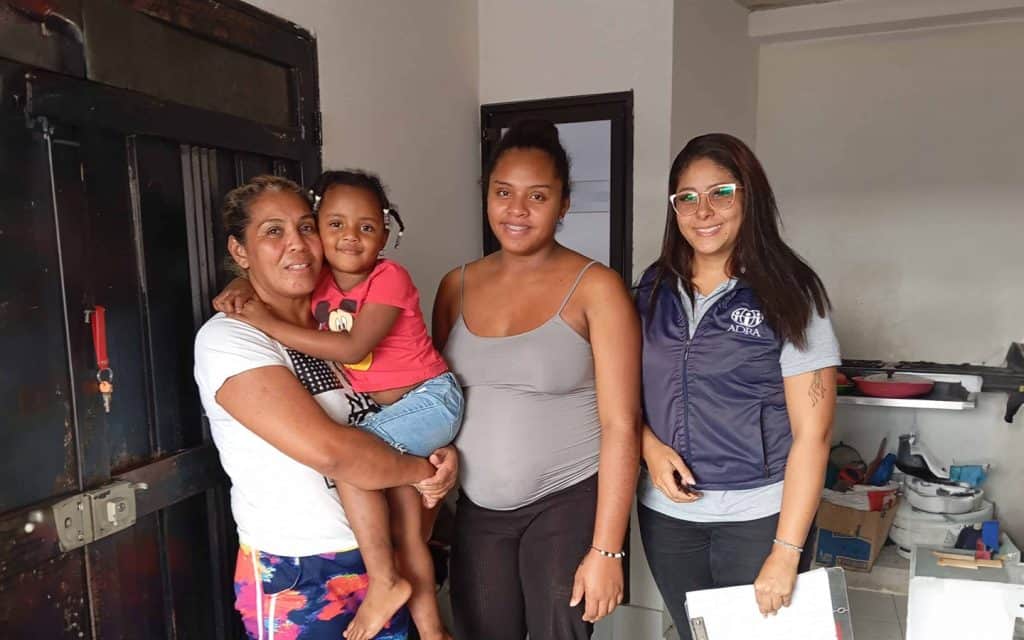 Healthy women and children receiving healthcare support from ADRA International during World Health.