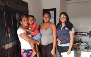 Healthy women and children receiving healthcare support from ADRA International during World Health.