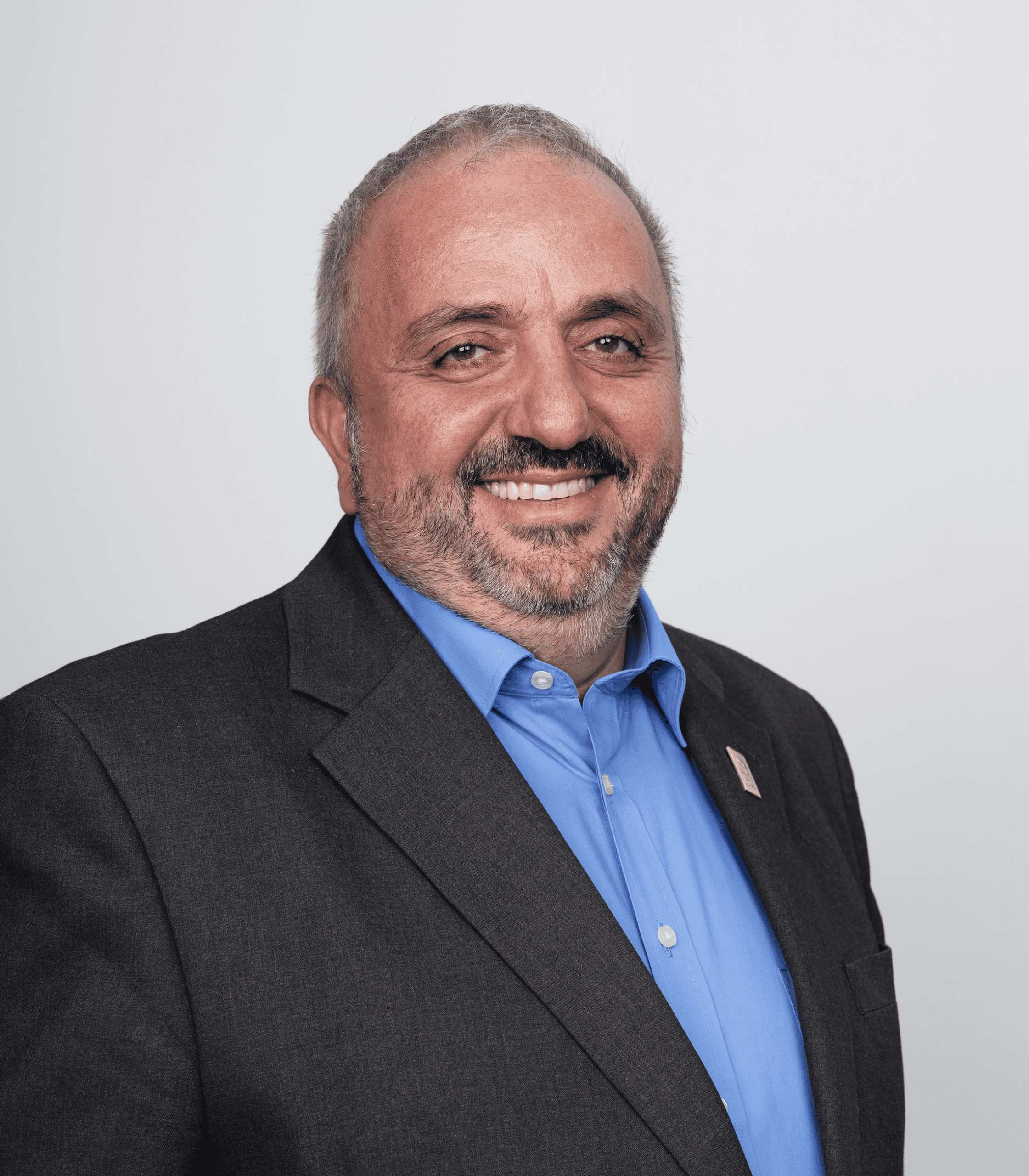 Empowered leader smiling in a professional portrait, representing ADRA International's leadership te.