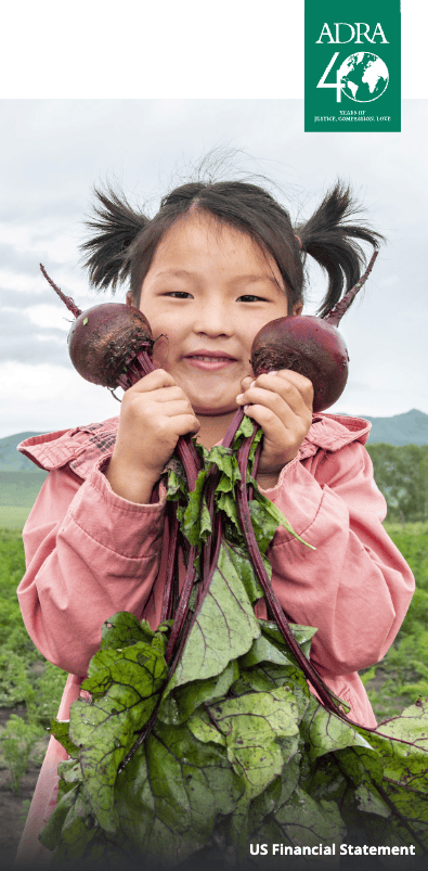 Young girl holding freshly harvested beets outdoors, smiling happily.